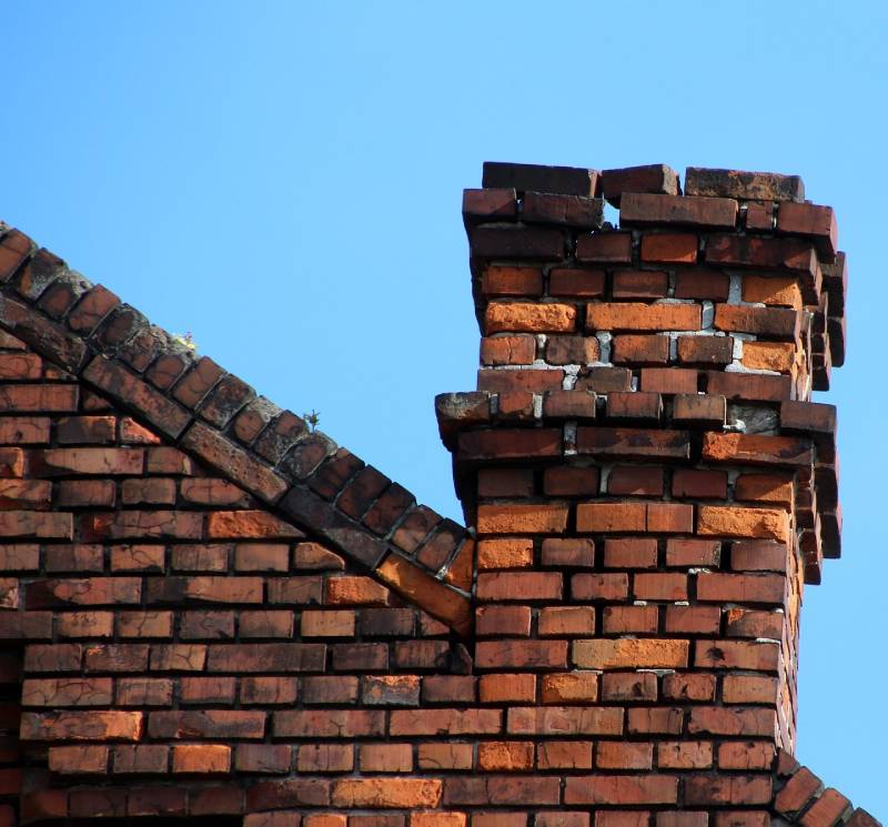 Damaged chimney on an Solana Beach home showing cracks and missing mortar